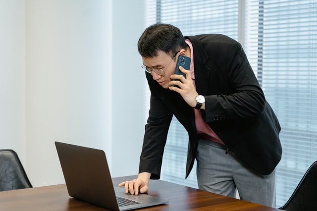 A sales representative on the phone with a customer.